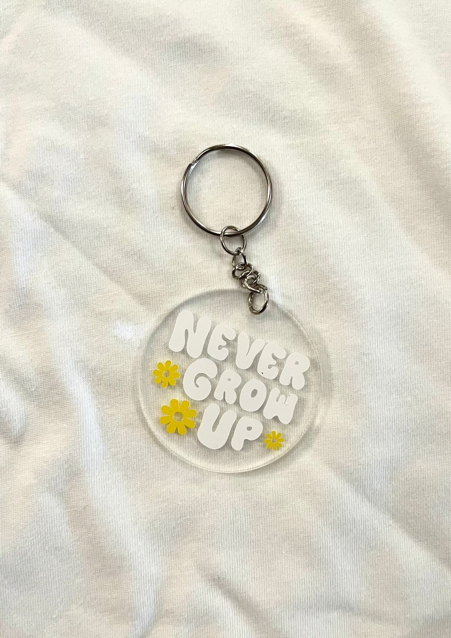 Never Grow Up round keychain